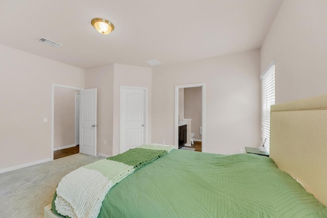 310 Garcitas Creek Ln, Hutto, TX 78634 - bedroom with carpet, baseboards, and ensuite bath
