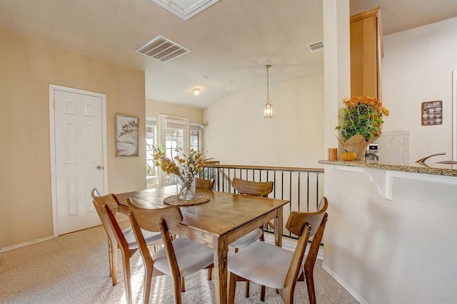 1310 W Parmer Ln Unit 2701, Austin, TX 78727 - dining space with vaulted ceiling, light carpet, and visible vents