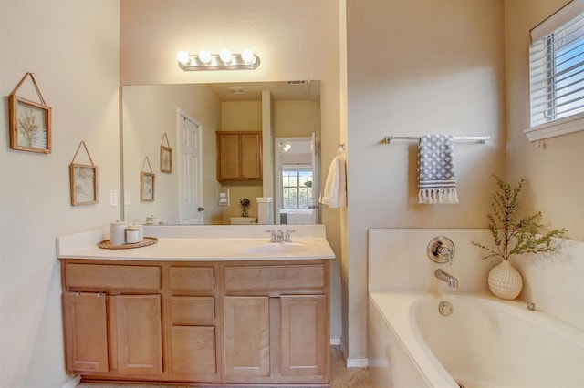 1310 W Parmer Ln Unit 2701, Austin, TX 78727 - bathroom featuring vanity, a wealth of natural light, and a garden tub