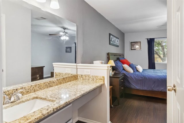 1610 Old Tract Rd, Pflugerville, TX 78660 - bedroom with dark wood-style floors, a sink, and a ceiling fan