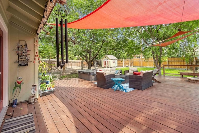 deck featuring an outdoor hangout area, an outdoor structure, a storage shed, and a fenced backyard