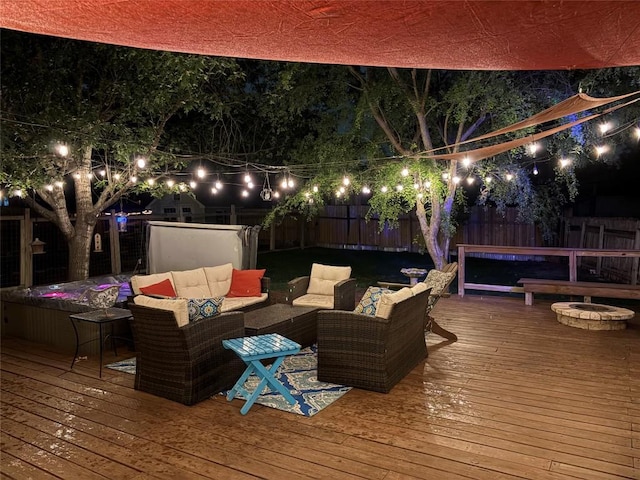 deck at twilight with a fenced backyard and outdoor lounge area