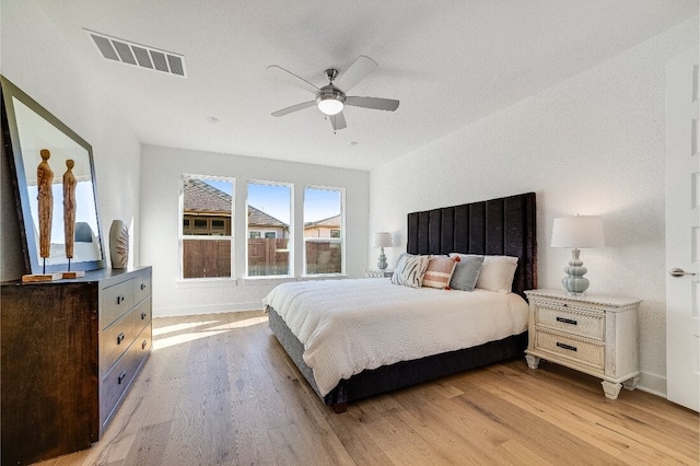 9413 Flatbush Dr, Austin, TX 78744 - bedroom with baseboards, light wood-style floors, visible vents, and a ceiling fan