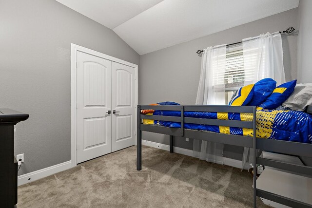 404 Buttercup Creek Blvd Unit 11, Cedar Park, TX 78613 - carpeted bedroom with lofted ceiling, baseboards, and a closet