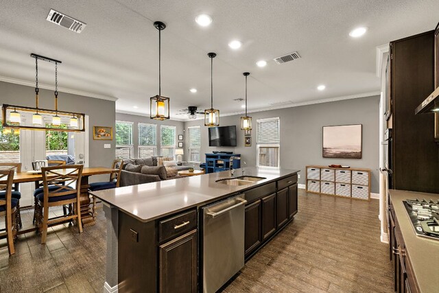 404 Buttercup Creek Blvd Unit 11, Cedar Park, TX 78613 - kitchen featuring stainless steel appliances, dark brown cabinets, recessed lighting, a sink, and ornamental molding