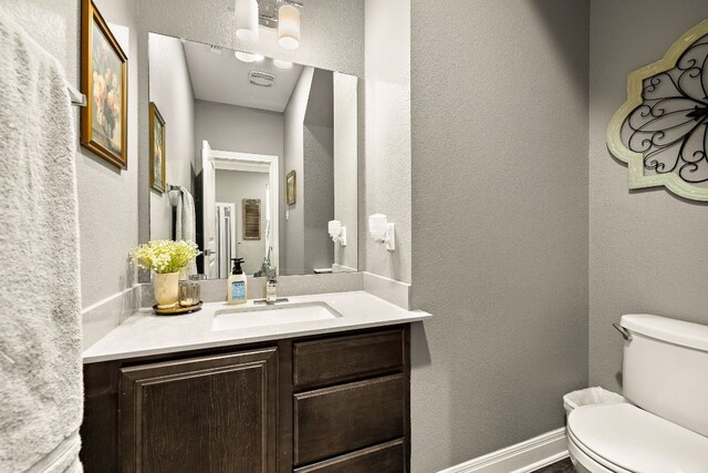 404 Buttercup Creek Blvd Unit 11, Cedar Park, TX 78613 - bathroom with vanity, toilet, and a textured wall