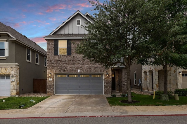 404 Buttercup Creek Blvd Unit 11, Cedar Park, TX 78613 - view of front facade with board and batten siding, brick siding, driveway, and an attached garage