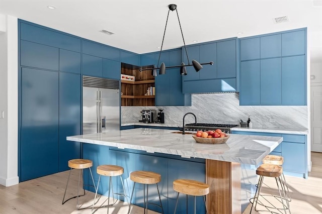 2901 Meandering River Ct, Austin, TX 78746 - kitchen featuring stainless steel built in refrigerator, light wood-style floors, tasteful backsplash, and modern cabinets