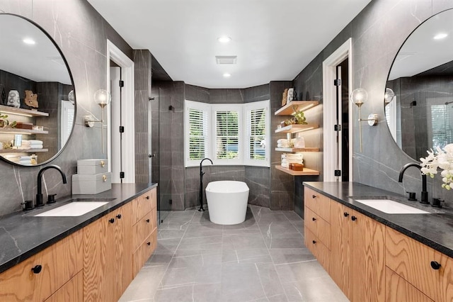 2901 Meandering River Ct, Austin, TX 78746 - bathroom with tile walls, a shower stall, two vanities, a freestanding tub, and marble finish flooring