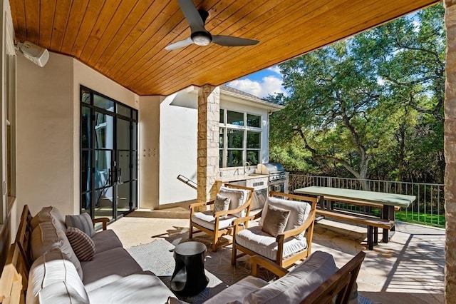 2901 Meandering River Ct, Austin, TX 78746 - view of patio / terrace with an outdoor living space, a grill, exterior kitchen, ceiling fan, and view of scattered trees