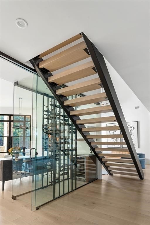 2901 Meandering River Ct, Austin, TX 78746 - wine cellar featuring wood finished floors and expansive windows