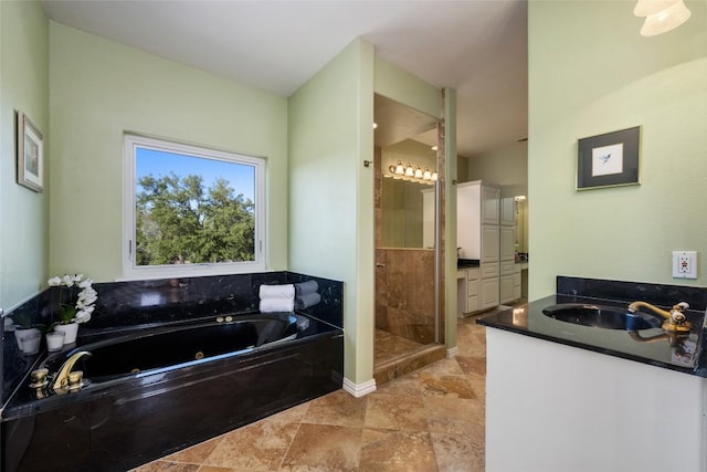 2400 W Fitzhugh Rd, Dripping Springs, TX 78630 - bathroom with vanity, a shower stall, and a tub with jets