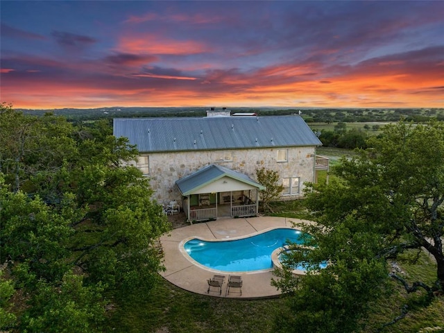 2400 W Fitzhugh Rd, Dripping Springs, TX 78630 - pool at dusk featuring a patio area and a pool with connected hot tub