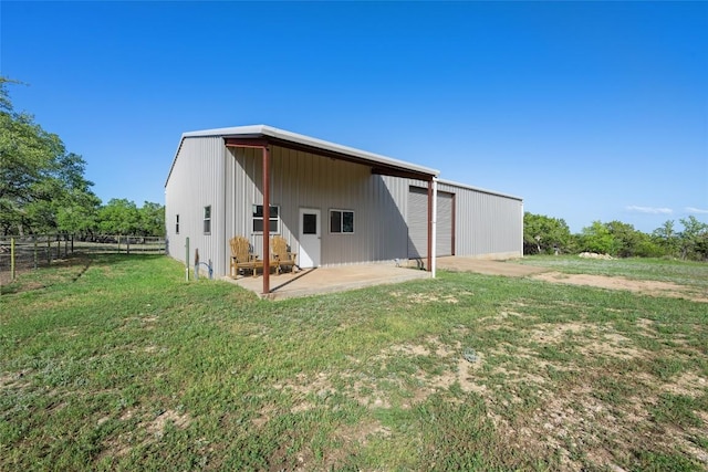 2400 W Fitzhugh Rd, Dripping Springs, TX 78630 - back of house featuring a detached garage, a patio area, and an outdoor structure