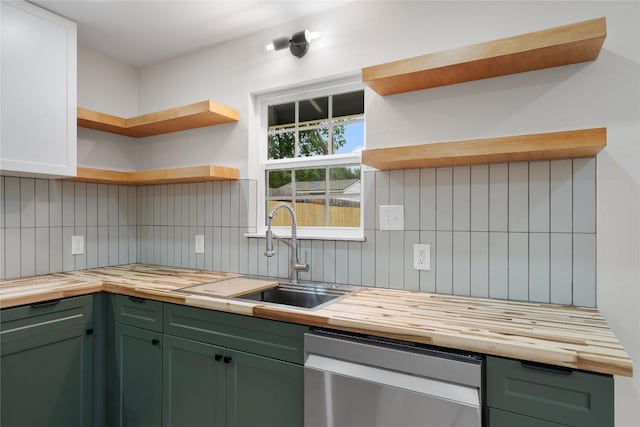 kitchen featuring butcher block countertops, tasteful backsplash, open shelves, green cabinets, and stainless steel dishwasher