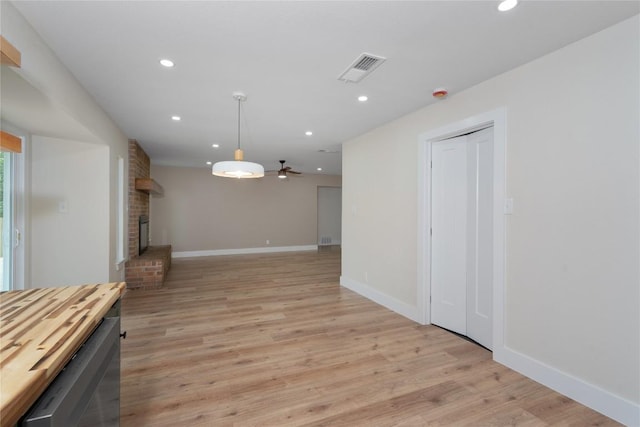 interior space featuring ceiling fan, visible vents, a fireplace, and recessed lighting