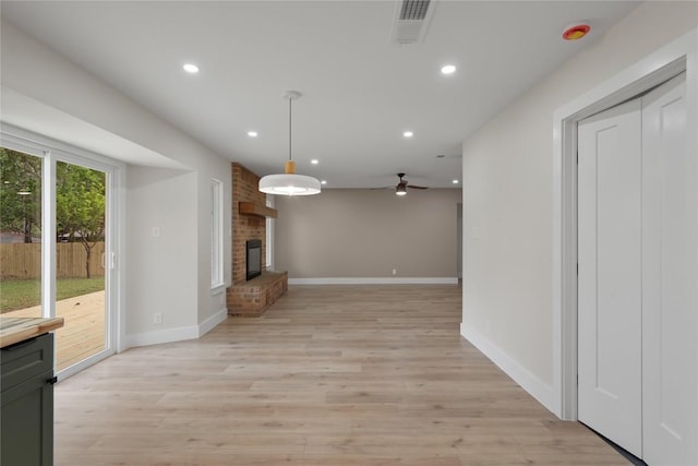 unfurnished living room featuring recessed lighting, a fireplace, visible vents, and light wood-style flooring
