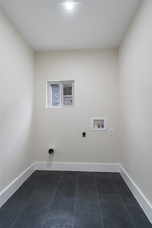 washroom with laundry area, hookup for an electric dryer, dark tile patterned flooring, baseboards, and hookup for a washing machine