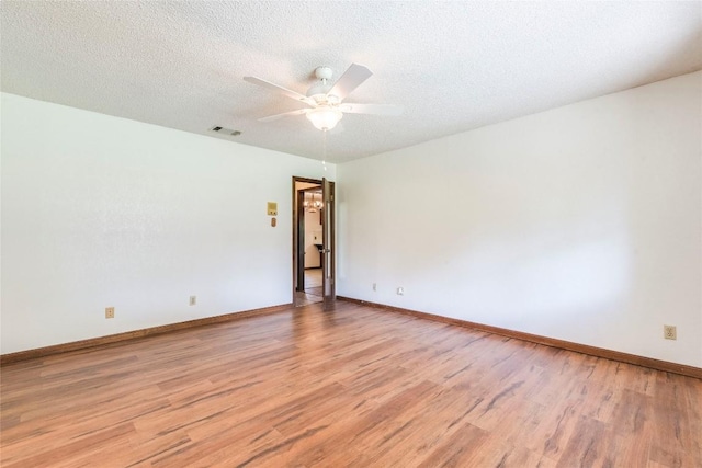 13505 Broadmeade Ave, Austin, TX 78729 - empty room featuring light wood finished floors, a ceiling fan, and a textured ceiling