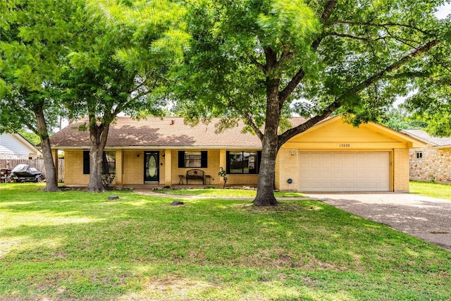 ranch-style house featuring covered porch, a garage, aphalt driveway, a front yard, and brick siding
