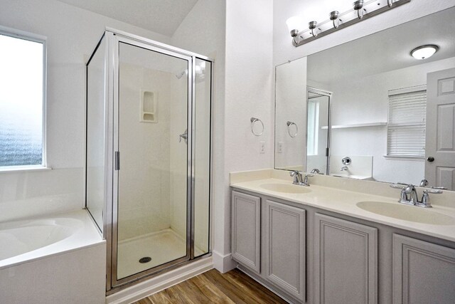 2539 Fayette Dr, New Braunfels, TX 78130 - bathroom featuring a shower stall, a garden tub, double vanity, and wood finished floors