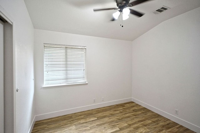 2539 Fayette Dr, New Braunfels, TX 78130 - spare room with vaulted ceiling, ceiling fan, baseboards, and wood finished floors
