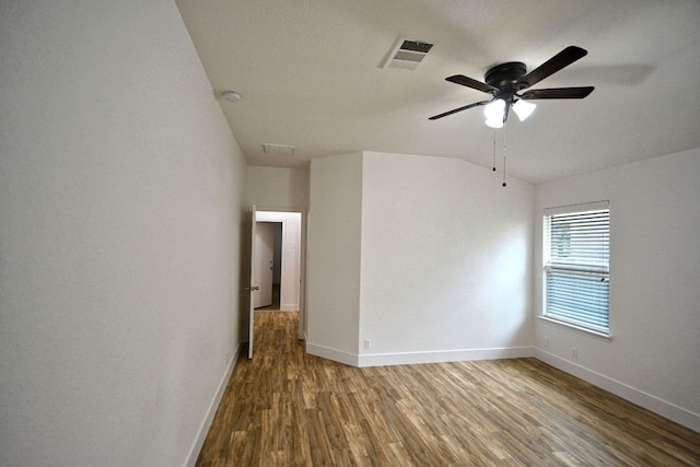 2539 Fayette Dr, New Braunfels, TX 78130 - spare room with baseboards, wood finished floors, vaulted ceiling, ceiling fan, and a smoke detector