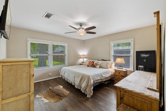 bedroom featuring baseboards, dark wood-style floors, visible vents, and multiple windows