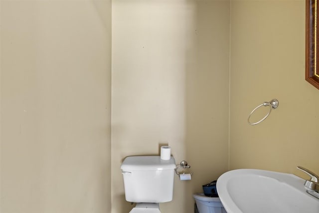 half bathroom with toilet and a sink