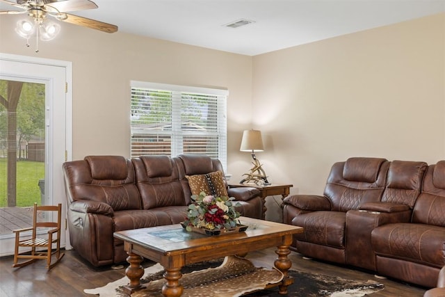 living room featuring a healthy amount of sunlight, dark wood finished floors, ceiling fan, and visible vents