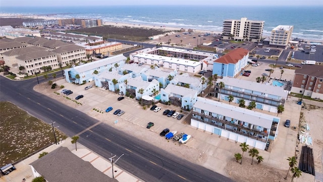 bird's eye view featuring a water view and a beach view