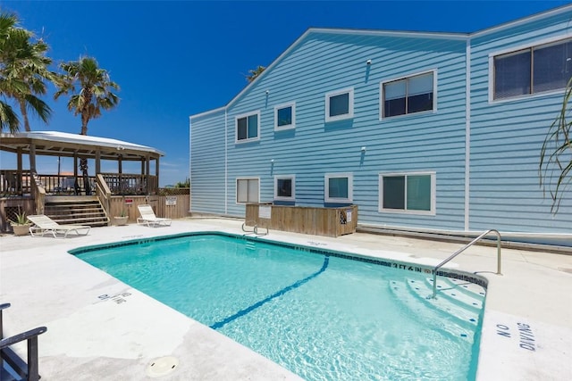 community pool featuring a gazebo and a patio