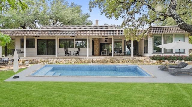 113 Comet, Lakeway, TX 78734 - back of house featuring a yard, a patio, a chimney, and an outdoor pool