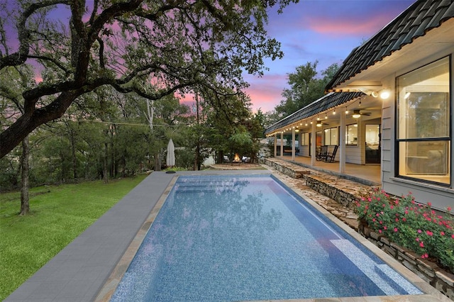 113 Comet, Lakeway, TX 78734 - pool at dusk with a patio, ceiling fan, a yard, and an outdoor pool