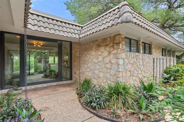 113 Comet, Lakeway, TX 78734 - property entrance with stone siding and a tiled roof