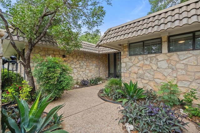 113 Comet, Lakeway, TX 78734 - entrance to property with stone siding, a tiled roof, and mansard roof