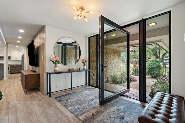 113 Comet, Lakeway, TX 78734 - entrance foyer featuring light wood finished floors, recessed lighting, and a notable chandelier