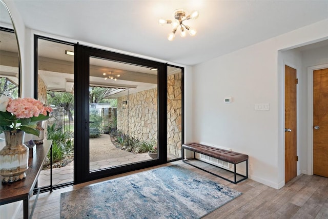 113 Comet, Lakeway, TX 78734 - interior space with wood finished floors, baseboards, and a notable chandelier