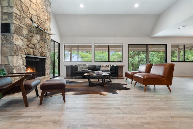 113 Comet, Lakeway, TX 78734 - living area featuring wood finished floors, high vaulted ceiling, a fireplace, visible vents, and baseboards