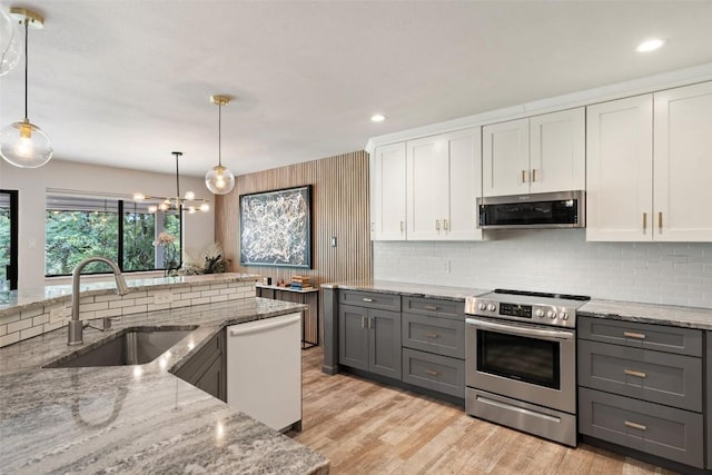 113 Comet, Lakeway, TX 78734 - kitchen featuring stainless steel appliances, white cabinets, gray cabinetry, and a sink