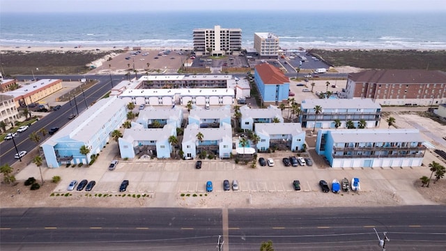 bird's eye view with a water view and a beach view