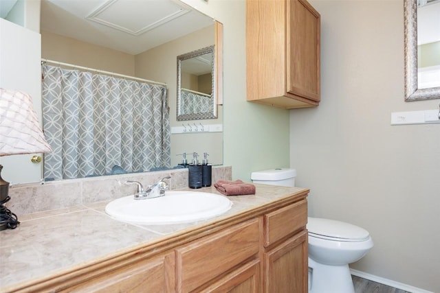 bathroom featuring toilet, a shower with shower curtain, wood finished floors, and vanity