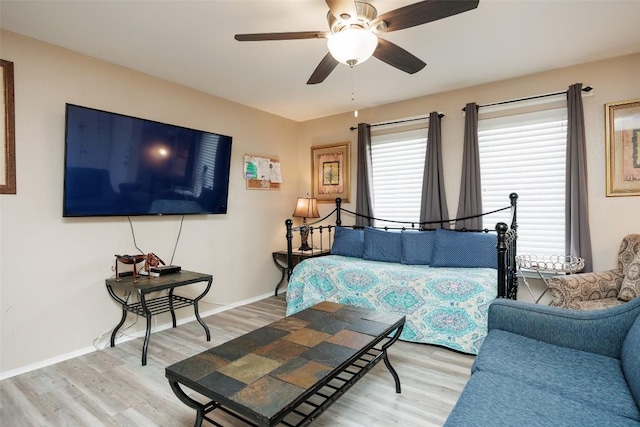 bedroom featuring ceiling fan, baseboards, and light wood-type flooring