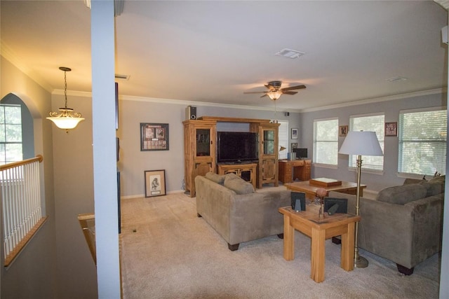 living area with visible vents, ceiling fan, light carpet, crown molding, and baseboards