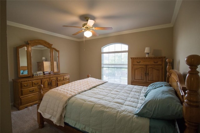 carpeted bedroom featuring crown molding and a ceiling fan