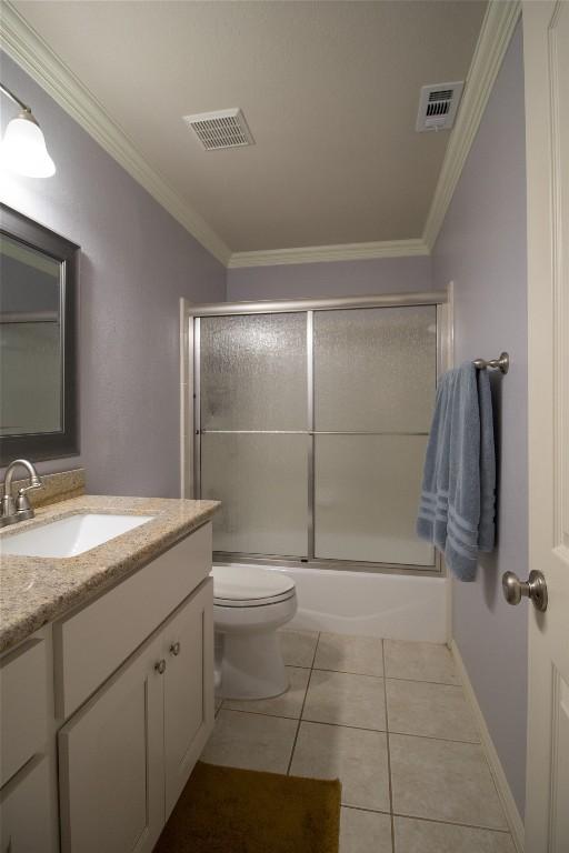 bathroom featuring crown molding, visible vents, tile patterned flooring, and vanity