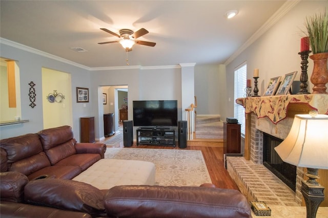 2005 Forest Hill Cv, Round Rock, TX 78665 - living area featuring a ceiling fan, crown molding, wood finished floors, and a fireplace with raised hearth