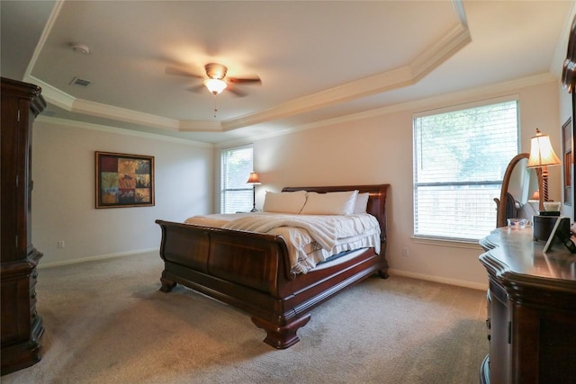 bedroom featuring a raised ceiling, ornamental molding, multiple windows, and carpet floors