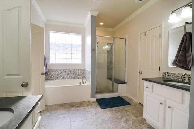 bathroom featuring a stall shower, vanity, crown molding, and a garden tub