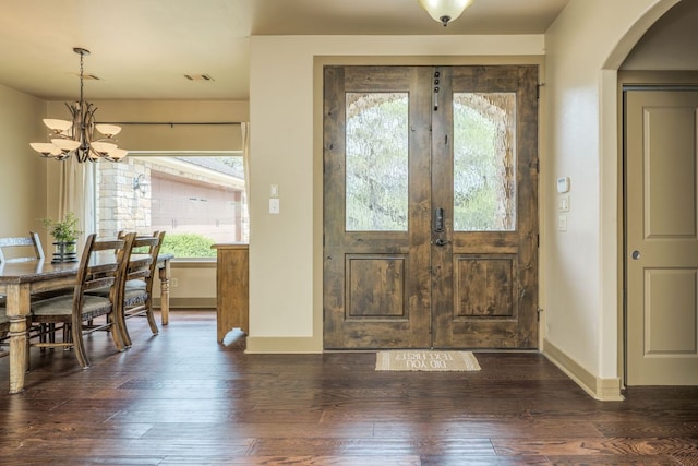 600 Mountain Dew Rd, Horseshoe Bay, TX 78657 - entryway with dark wood-type flooring, visible vents, arched walkways, a notable chandelier, and baseboards